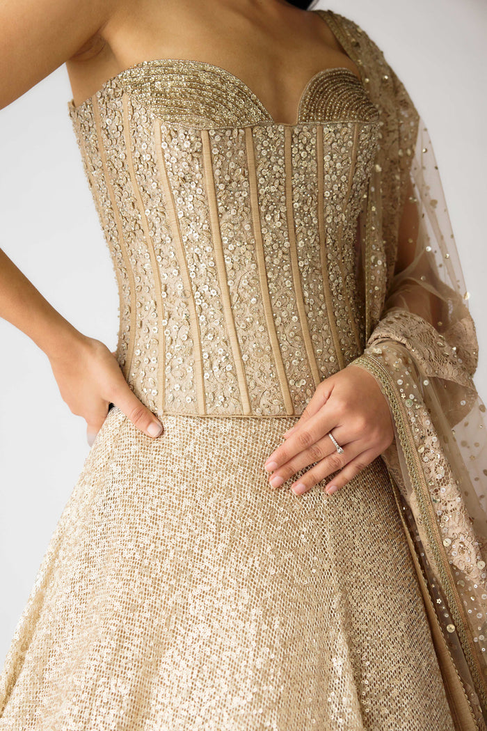 GOLDEN LEHENGA FEATURING EMBELLISHED CORSET BLOUSE