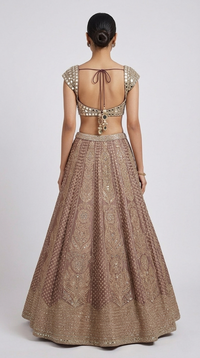 Designer brown lehenga choli with mirror embroidery, flared skirt and embellished dupatta for festive occasions.