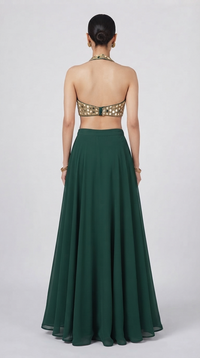 Back view of designer green lehenga with mirror work halter blouse, flared skirt and coordinated dupatta.