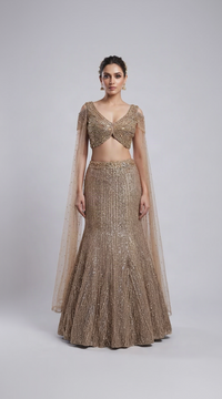 Champagne embroidered fish cut lehenga set with embellished blouse, intricate embroidery and crystal tassel details