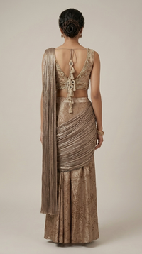 Back view of dusty brown pre-draped saree with embroidered blouse, decorative tie details and tassels, suitable for weddings and evening events