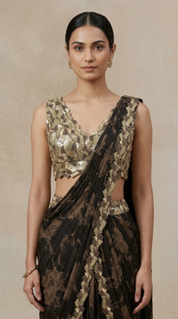 Close-up of black printed saree and hand-embroidered blouse with detailed cutdana, sequins and beads, suitable for receptions, festive occasions and parties