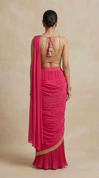 Hand-embellished rani pink pre-draped saree with intricate detailing, designer party wear outfit for women.