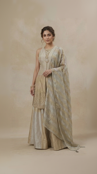 Cream tissue silk salwar suit with elegant embroidery, perfect for weddings, sangeet, festivals, puja, receptions and festive party wear.