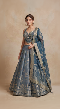 Teal blue Zardosi embroidered Banarasi silk lehenga choli set for weddings and receptions by Nishly Fashion House