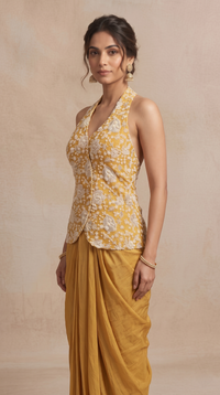 Yellow halter neck crop top with sequin embroidery and pleated skirt, stylish ethnic party wear for weddings, engagement and bridesmaid celebrations.