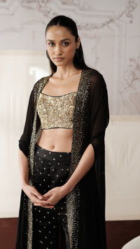 Close-up of black sequins embellished cape style sharara set with gold sequin detailing