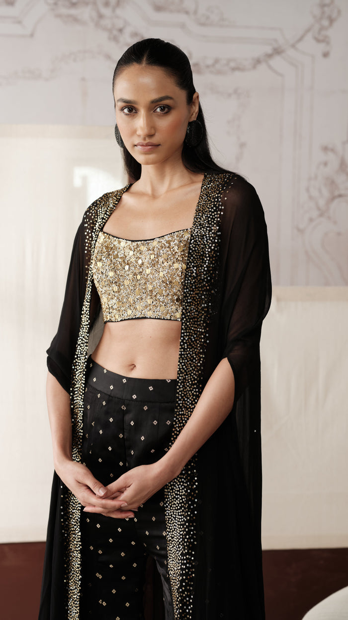 Close-up of black sequins embellished cape style sharara set with gold sequin detailing