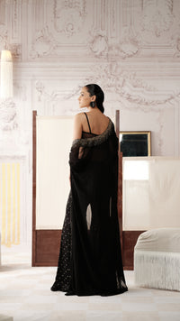Back view of black sequins embellished cape style sharara set with detailed cape