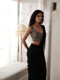 Close-up of black saree with mirror work and sequin embellishments