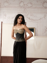 Black embroidered corset and pleated skirt outfit for engagement
