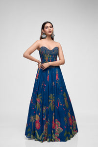Front view of blue printed lehenga choli featuring intricate bead embroidery and stylish corset blouse for reception and engagement parties.