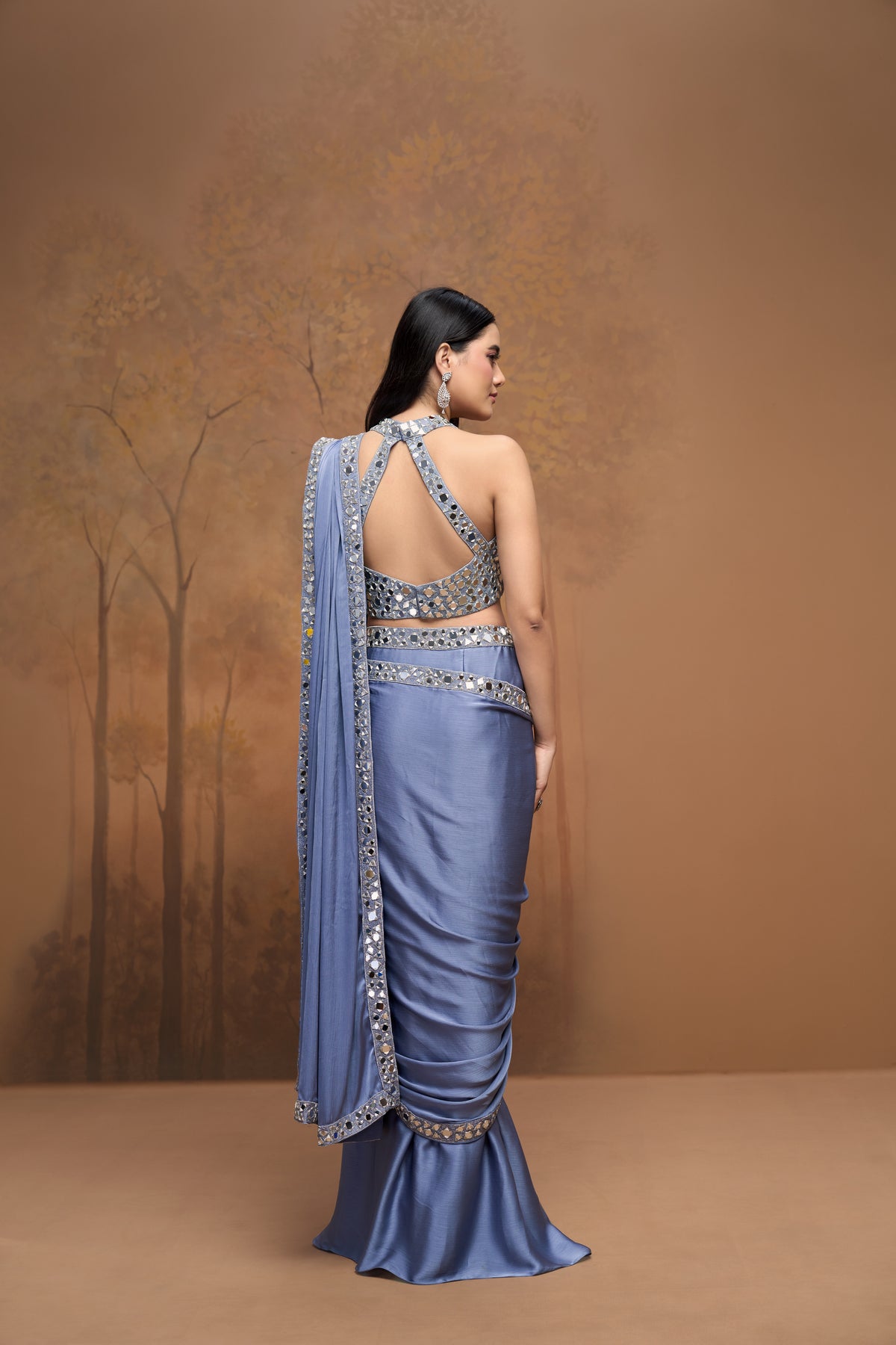 Designer blue halter neck saree with intricate mirror detailing for modern Indian wedding wear