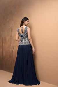 Detailed view of blue embroidered sharara set with sparkling mirror work and a contemporary festive silhouette.