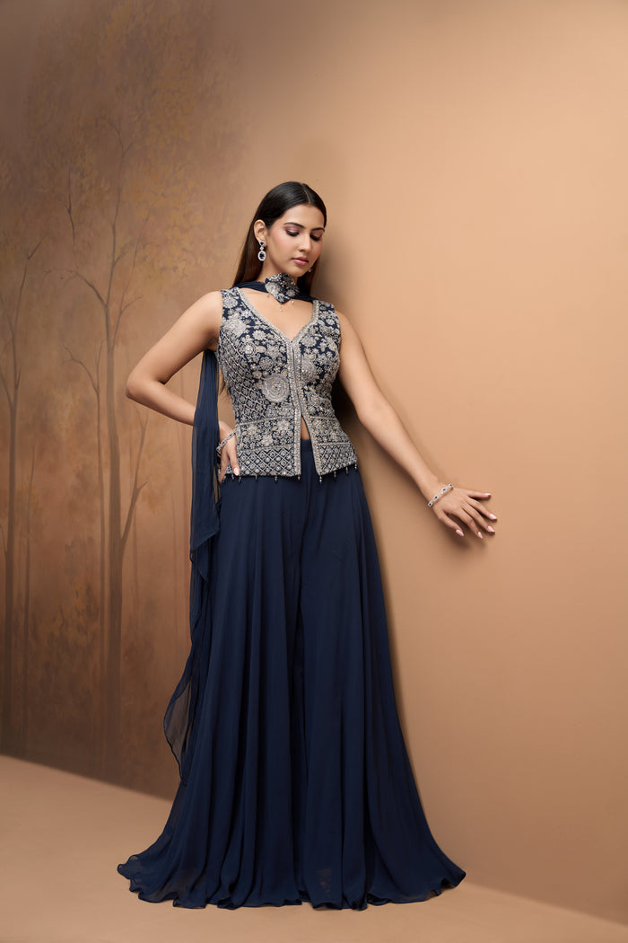 Front view of blue mirror work sharara set featuring intricate embroidery and elegant festive detailing.