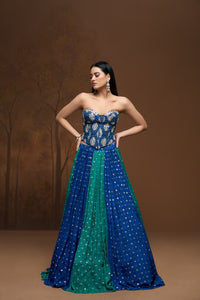 Front view of green mirror work corset lehenga featuring intricate embroidery and elegant ethnic detailing for reception and engagement parties.