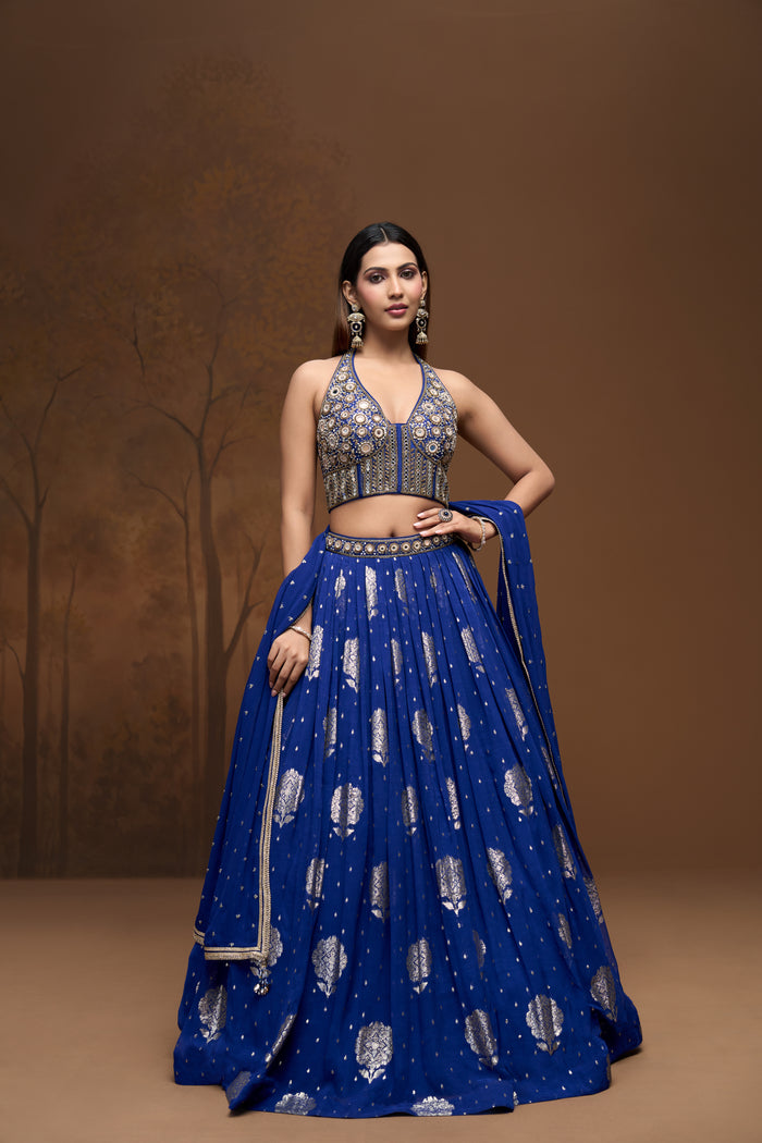 Front view of cobalt blue embroidered lehenga choli featuring luxurious Banarasi georgette fabric and elegant embellishments.