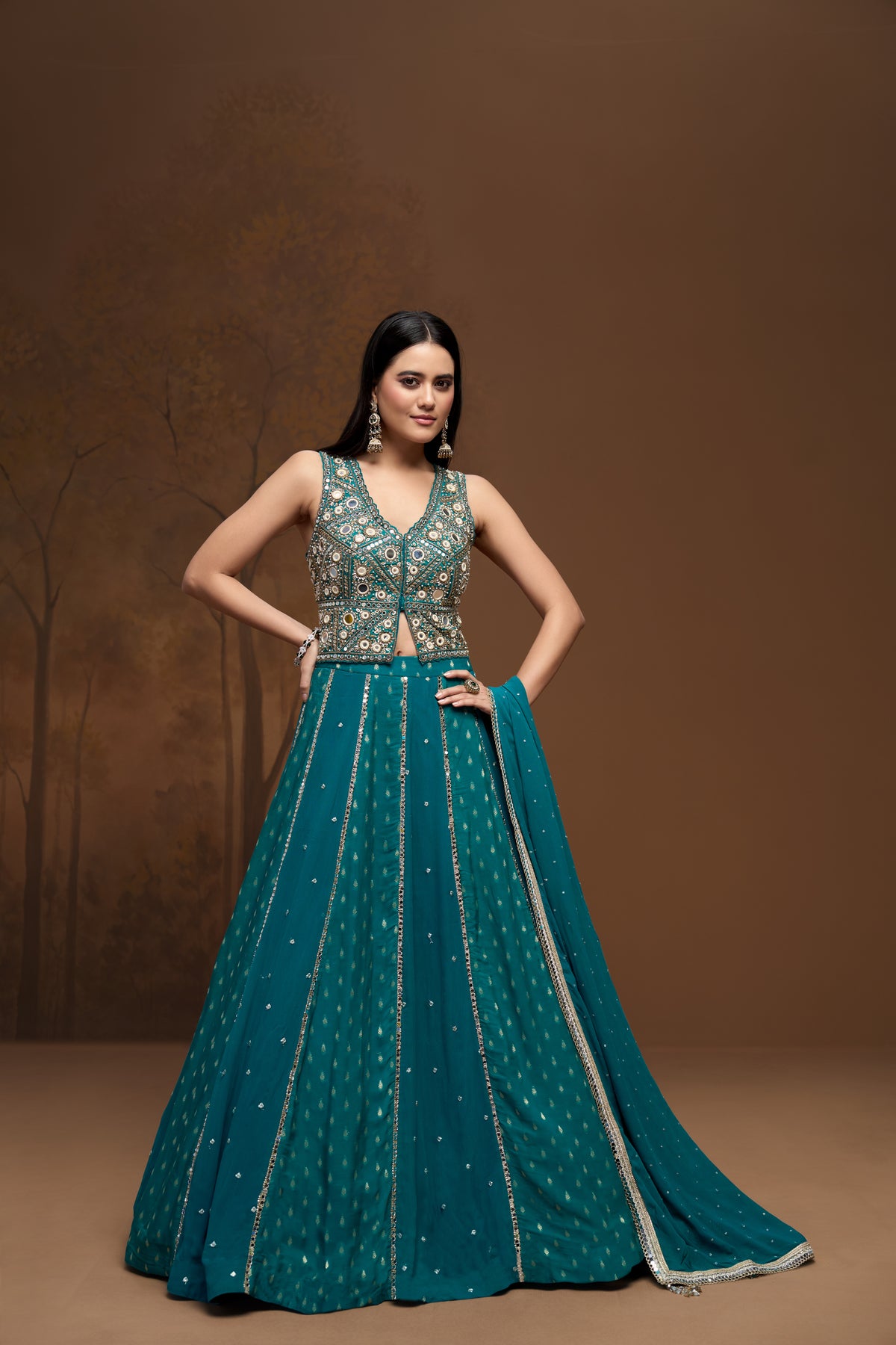 Front view of green embroidered lehenga set featuring intricate mirror work and elegant georgette fabric for sangeet and mehendi occasions.