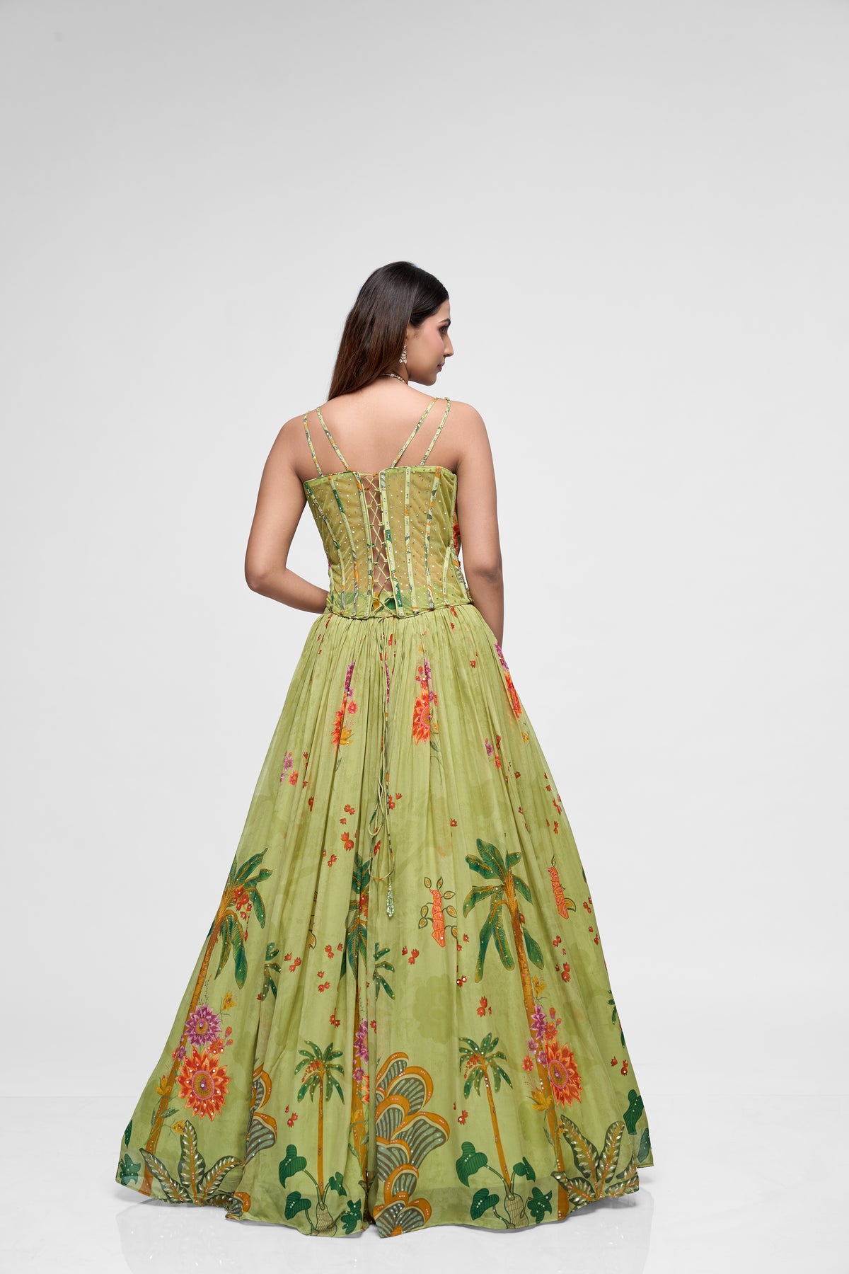 Detailed view of green printed lehenga with flower embroidery and contemporary corset blouse, perfect for sangeet, reception, and party wear.