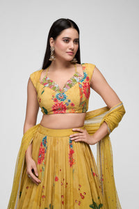 Front view of mustard embroidered lehenga choli with sparkling sequins, printed georgette fabric, and elegant cap sleeves for sangeet and haldi ceremonies.