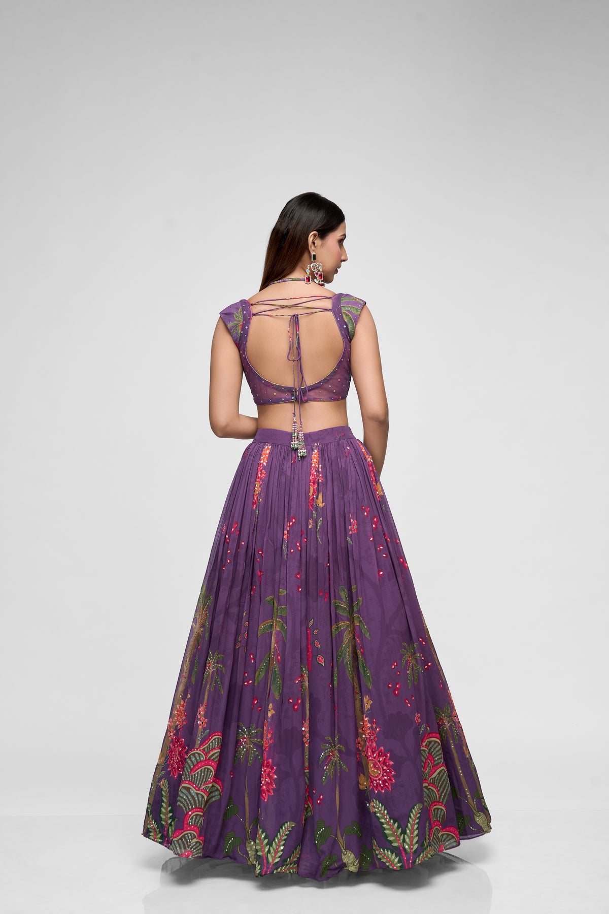 Detailed view of purple printed georgette lehenga with intricate sequin embroidery and cap sleeves, perfect for Indian ethnic wedding and party wear.