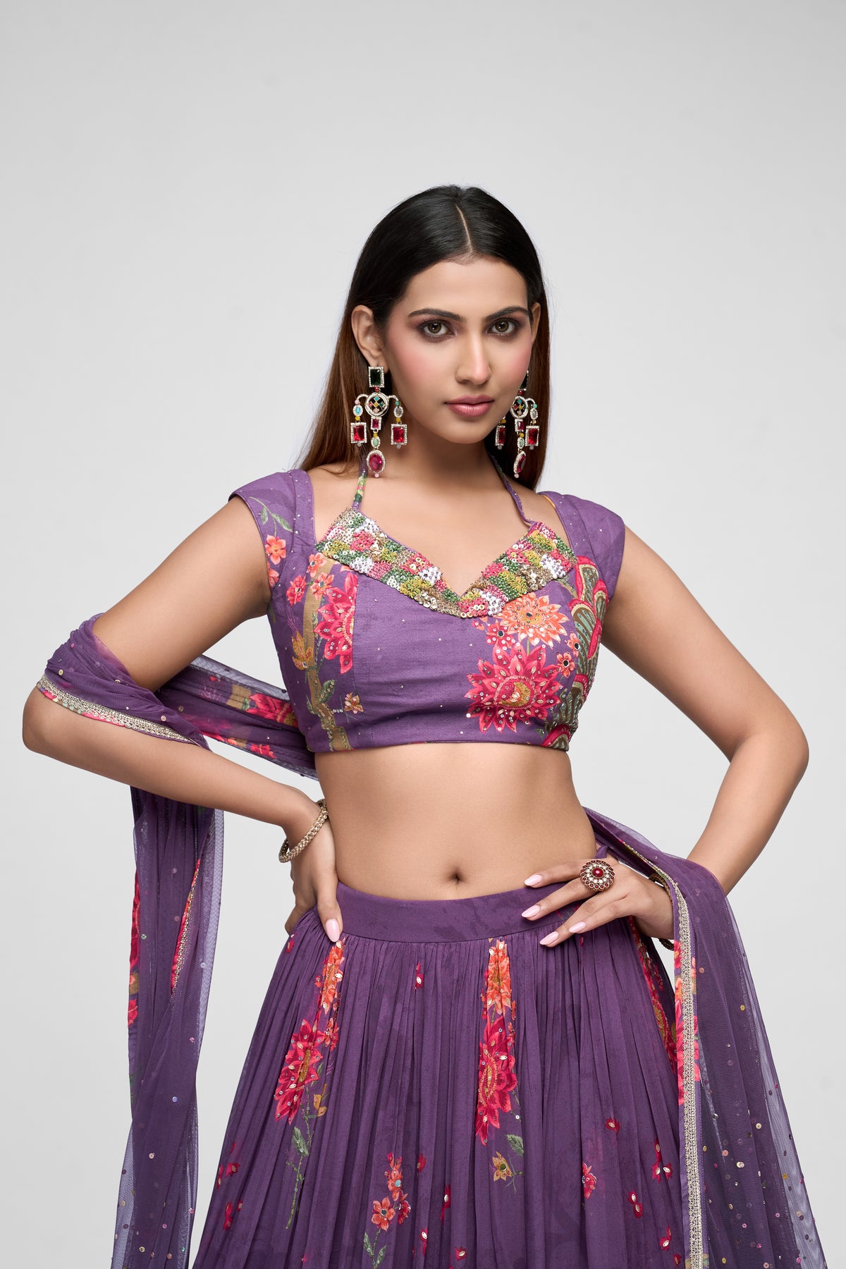 Stylish purple sequins lehenga set with printed georgette skirt and embroidered blouse, ideal for engagement parties and festive occasions.