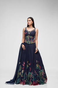 Front view of black printed lehenga choli featuring intricate floral embroidery and corset-style blouse for reception and engagement parties.