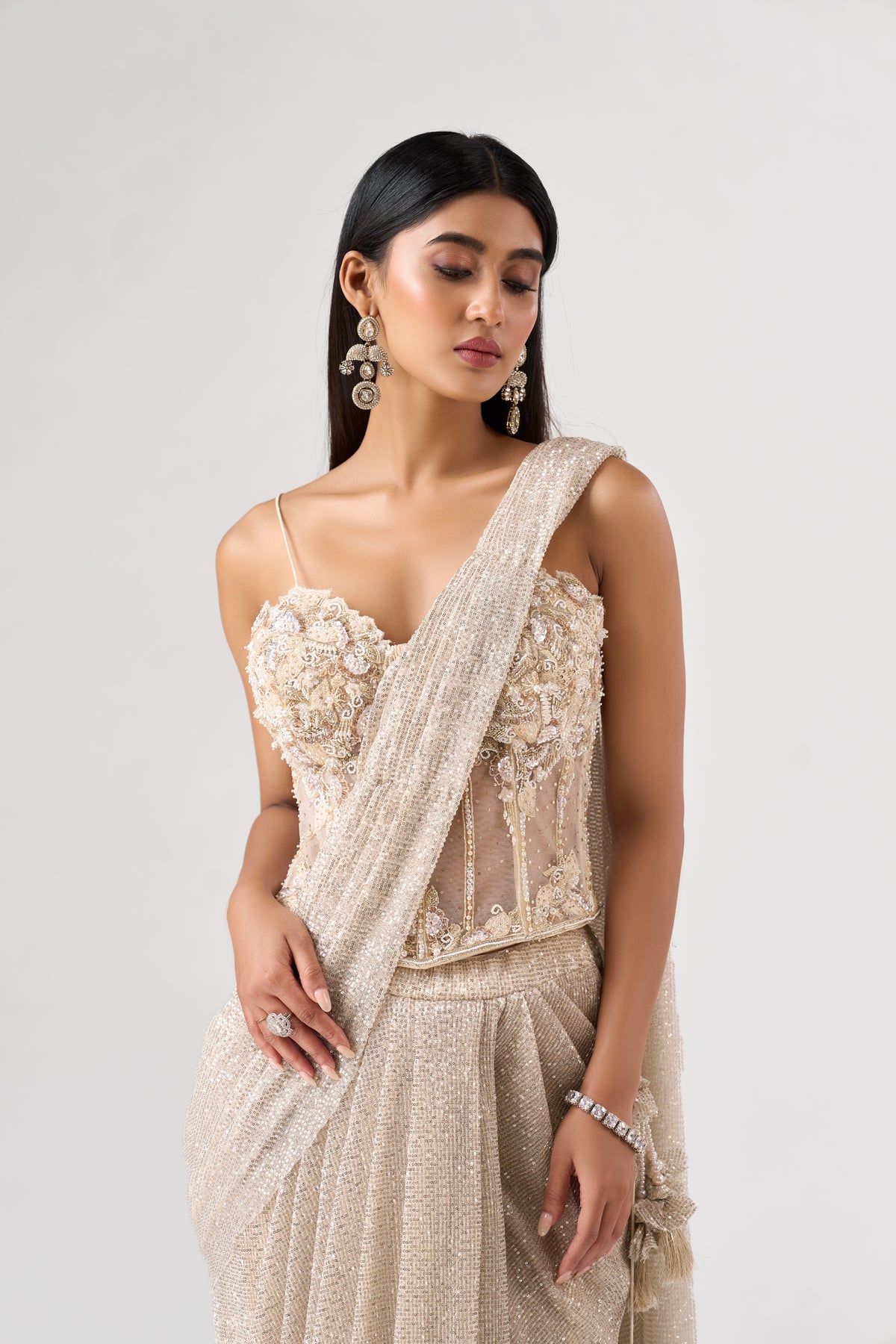 IVORY SEQUINS EMBELLISHED CORSET PRE DRAPED SAREE | Nishly Fashion House