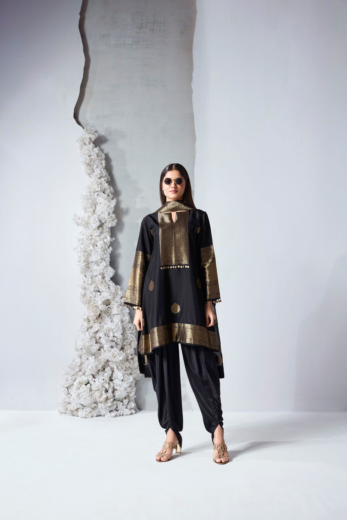 Black woven silk dhoti kameez set with brass coin detailing for festive and party wear