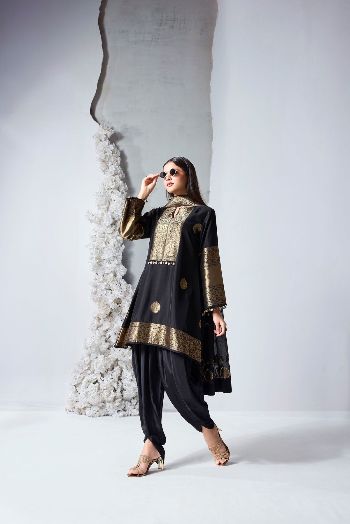 Black silk dhoti salwar set with woven detailing and dupatta for Diwali, weddings and celebrations