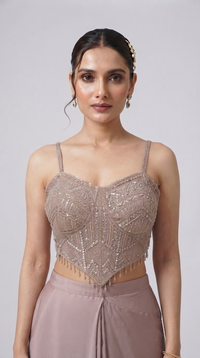 Pink embroidered pre-draped saree set with crystal tassels and embellished corset blouse