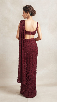 Red cocktail pre-draped saree set styled with embroidered blouse