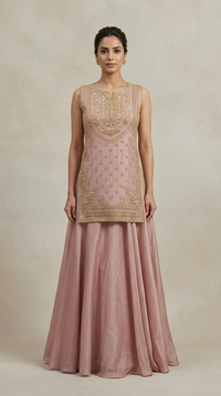 Pink tissue silk lehenga featuring intricate embroidery and embellished blouse